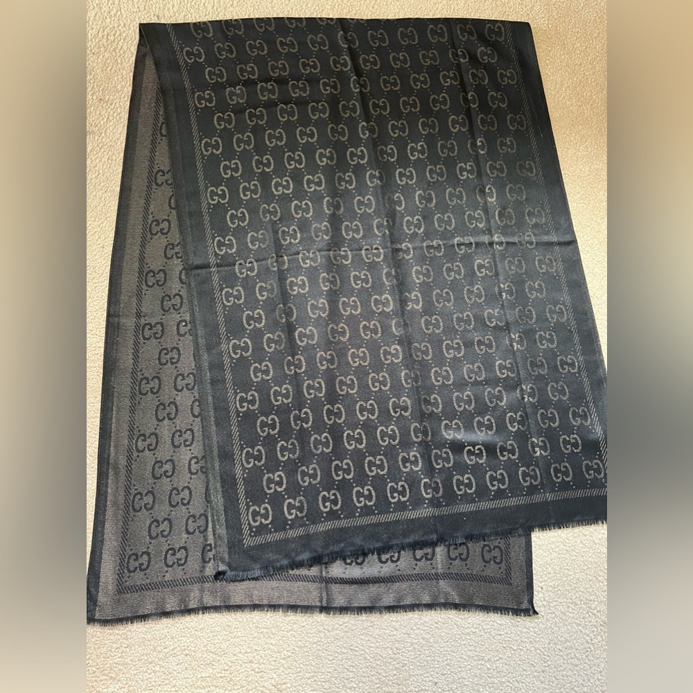 Gucci reversible black and gold shawl.
